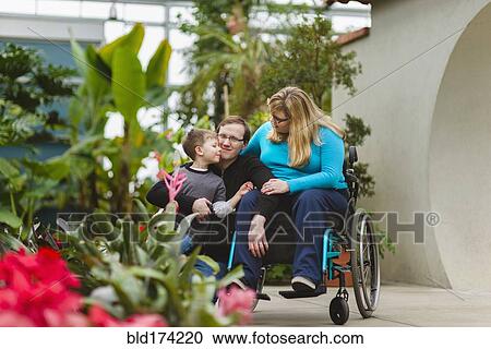 Paraplegic woman and family hugging in garden View Large Photo Image Stock Image - Paraplegic woman and family hugging in garden. Fotosearch
