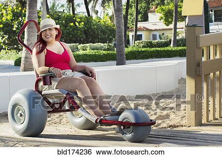 Stock Photograph - Paraplegic woman in wheelchair in park. Fotosearch