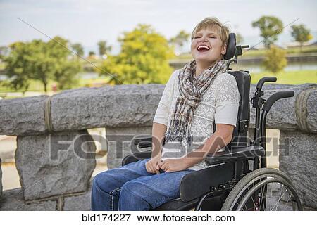 Stock Photo - Paraplegic woman laughing in wheelchair. Fotosearch