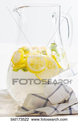 Stock Image - Pitcher of herbal lemon water. Fotosearch