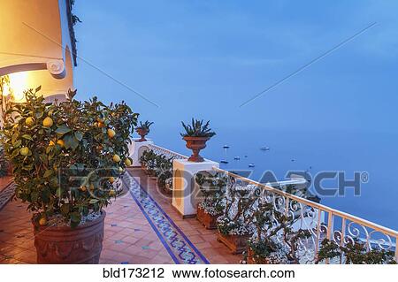Stock Image - Plants on balcony overlooking seascape. Fotosearch