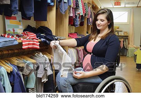 Pregnant paraplegic woman in wheelchair shopping in baby store View Large Photo Image Stock Photo - Pregnant paraplegic woman in wheelchair shopping in baby store. Fotosearch