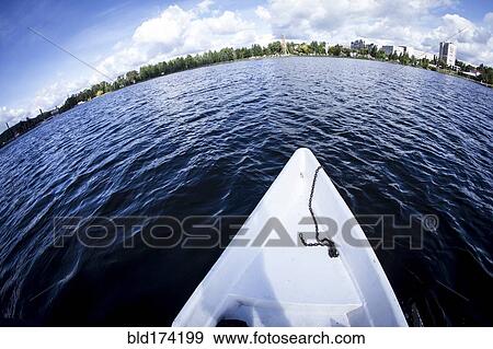 Stock Photo - Rowboat floating in lake. Fotosearch
