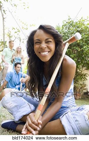Smiling woman holding croquet mallet in backyard View Large Photo Image Picture - Smiling woman holding croquet mallet in backyard. Fotosearch