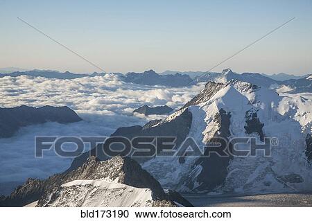Snowy mountaintops in remote landscape View Large Photo Image Stock Image - Snowy mountaintops in remote landscape. Fotosearch