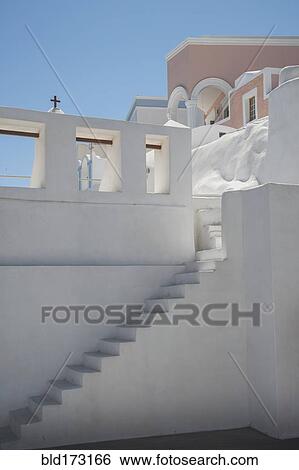 Steps on building wall under blue sky View Large Photo Image Stock Photograph - Steps on building wall under blue sky. Fotosearch