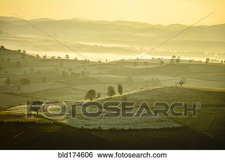 Sunrise over farmland in rural landscape View Large Photo Image Stock Photograph - Sunrise over farmland in rural landscape. Fotosearch