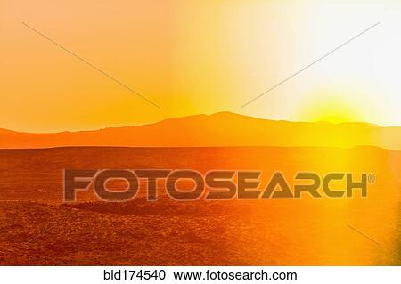 Stock Image - Sunset over desert landscape. Fotosearch