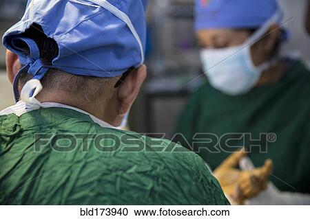 Surgeon working in operating room View Large Photo Image Stock Image - Surgeon working in operating room. Fotosearch