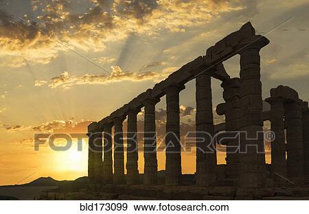 Stock Photo - Temple of Poseidon ruins under sunset sky, Cap Sunion, Greece. Fotosearch