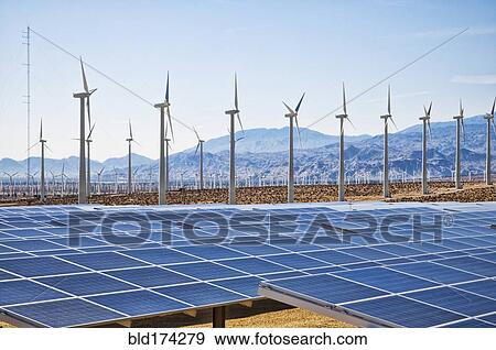 Wind turbines and solar panels in remote landscape View Large Photo Image Stock Photo - Wind turbines and solar panels in remote landscape. Fotosearch