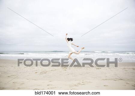 Woman jumping for joy on beach View Large Photo Image Stock Image - Woman jumping for joy on beach. Fotosearch