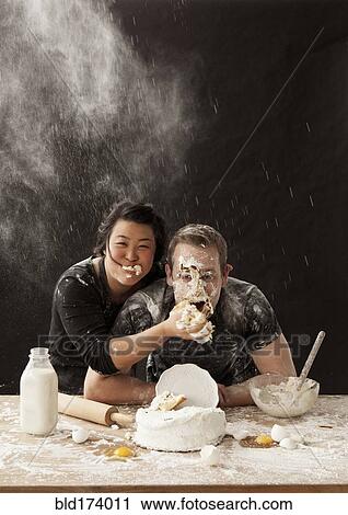 Woman shoving cake in face of boyfriend View Large Photo Image Stock Image - Woman shoving cake in face of boyfriend. Fotosearch