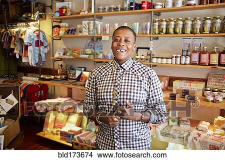 Woman smiling in store View Large Photo Image Picture - Woman smiling in store. Fotosearch