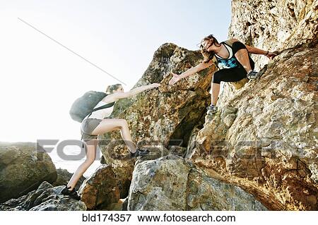 Women climbing on boulders View Large Photo Image Stock Photo - Women climbing on boulders. Fotosearch