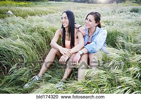 Women sitting in field View Large Photo Image Stock Image - Women sitting in field. Fotosearch