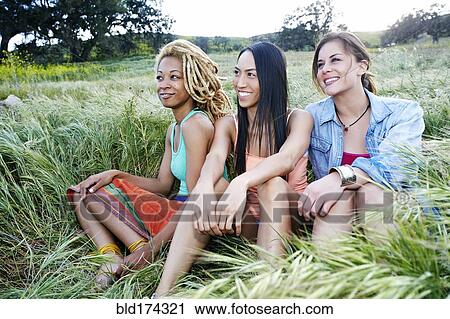 Women sitting in field View Large Photo Image Stock Image - Women sitting in field. Fotosearch