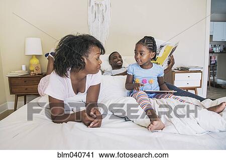 African American parents and daughter on bed View Large Photo Image Stock Image - African American parents and daughter on bed. Fotosearch