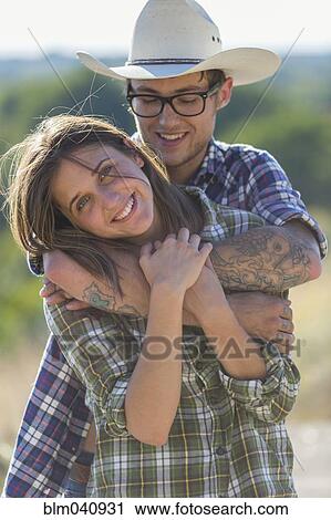 Stock Image - Caucasian couple hugging outdoors. Fotosearch
