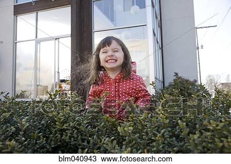 Caucasian girl smiling in bush View Large Photo Image Stock Image - Caucasian girl smiling in bush. Fotosearch