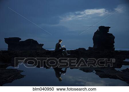 Caucasian teenage boy exploring rocky tidal pools at night, Canggu, Bali, Indonesia View Large Photo Image Stock Image - Caucasian teenage boy exploring rocky tidal pools at night, Canggu, Bali, Indonesia. Fotosearch