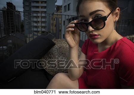 Caucasian woman peering over sunglasses View Large Photo Image Stock Image - Caucasian woman peering over sunglasses. Fotosearch