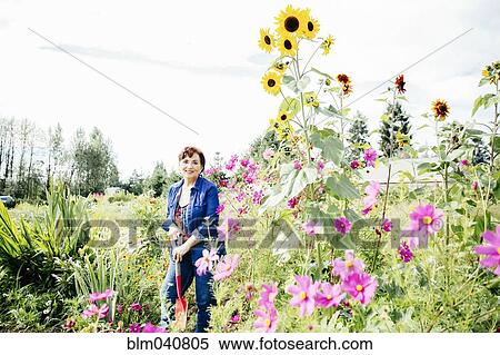 Stock Photography - Caucasian woman smiling in garden. Fotosearch