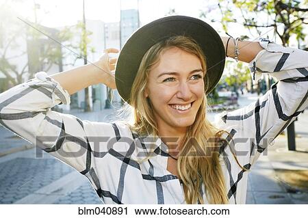 Stock Image - Caucasian woman smiling outdoors. Fotosearch