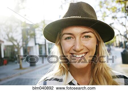Stock Image - Caucasian woman smiling outdoors. Fotosearch