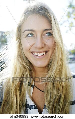 Stock Image - Caucasian woman smiling outdoors. Fotosearch