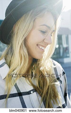 Stock Image - Caucasian woman smiling outdoors. Fotosearch