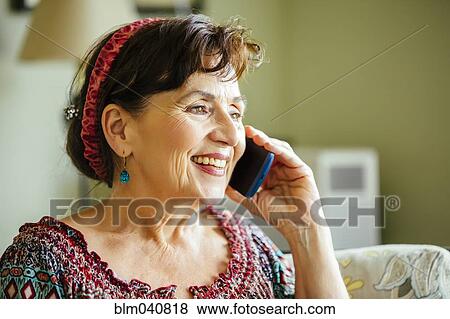 Stock Photo - Caucasian woman talking on cell phone. Fotosearch