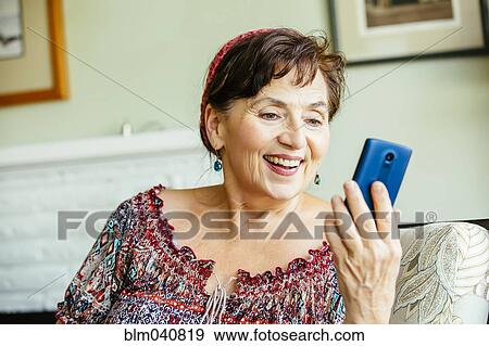 Stock Photo - Caucasian woman using cell phone. Fotosearch