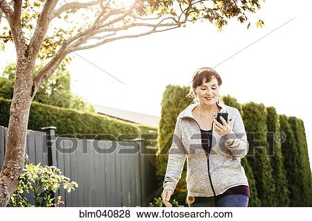 Caucasian woman using cell phone outdoors View Large Photo Image Stock Photo - Caucasian woman using cell phone outdoors. Fotosearch