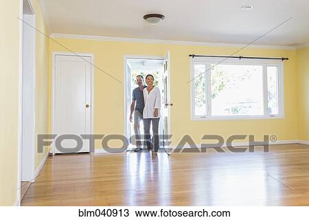 Stock Image - Couple admiring new home. Fotosearch