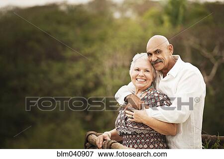 Stock Photo - Couple hugging on balcony. Fotosearch
