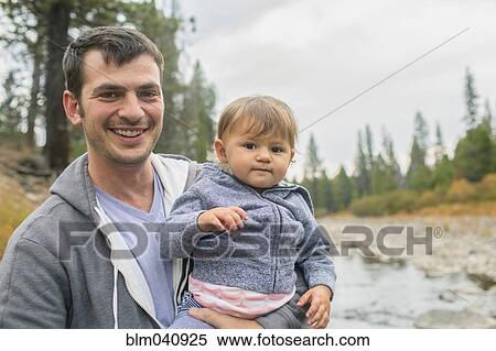 Father carrying daughter at river View Large Photo Image Stock Photography - Father carrying daughter at river. Fotosearch