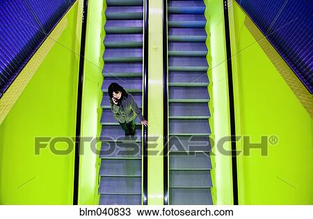 Japanese woman riding escalator View Large Photo Image Stock Image - Japanese woman riding escalator. Fotosearch