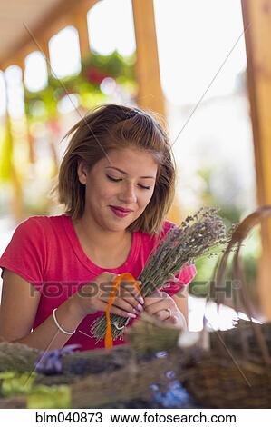 Mixed race girl tying bundle of flowers View Large Photo Image Stock Image - Mixed race girl tying bundle of flowers. Fotosearch