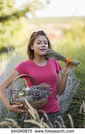 Mixed race woman smelling flowers in garden View Large Photo Image Stock Photography - Mixed race woman smelling flowers in garden. Fotosearch