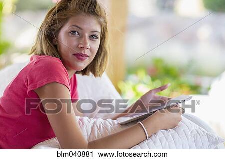 Mixed race woman using digital tablet View Large Photo Image Stock Image - Mixed race woman using digital tablet. Fotosearch