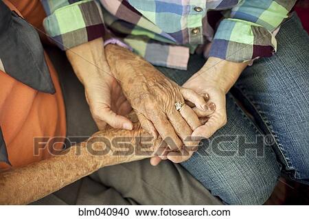 Stock Image - Mother and daughter holding hands. Fotosearch