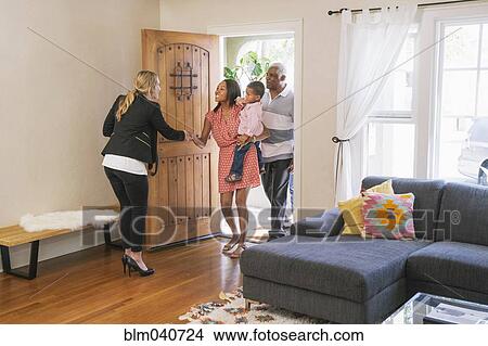 Picture - Real estate agent showing house to clients. Fotosearch