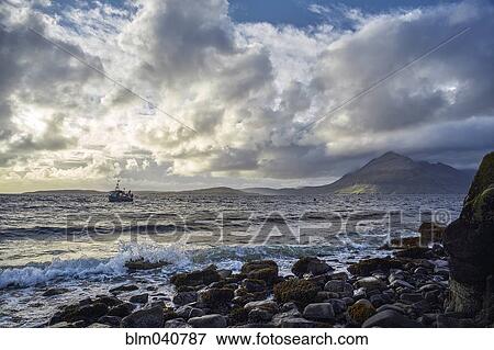 Stock Photo - Waves on rocky beach. Fotosearch