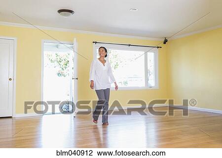 Stock Image - Woman admiring new home. Fotosearch