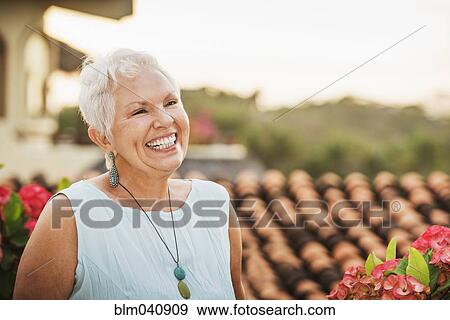 Woman laughing outdoors View Large Photo Image Stock Photo - Woman laughing outdoors. Fotosearch