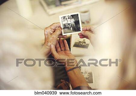 Women looking at family photographs View Large Photo Image Stock Photo - Women looking at family photographs. Fotosearch