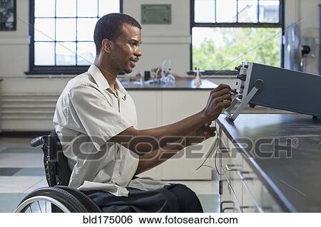 African American paraplegic student performing experiment in science classroom View Large Photo Image Stock Photograph - African American paraplegic student performing experiment in science classroom. Fotosearch