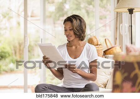 African American woman reading paperwork View Large Photo Image Stock Photo - African American woman reading paperwork. Fotosearch