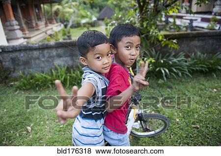 Asian boys playing in backyard View Large Photo Image Stock Photo - Asian boys playing in backyard. Fotosearch